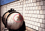 Photographs of the storage tank at the Kuwaiti Girls' School taken by the safety officer in August 1991.&nbsp; Encircled areas show the movement of the fumes out of one of the bullet holes.&nbsp;(Photographs used by permission.)